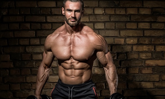 bodybuilder holding dumbbells promo